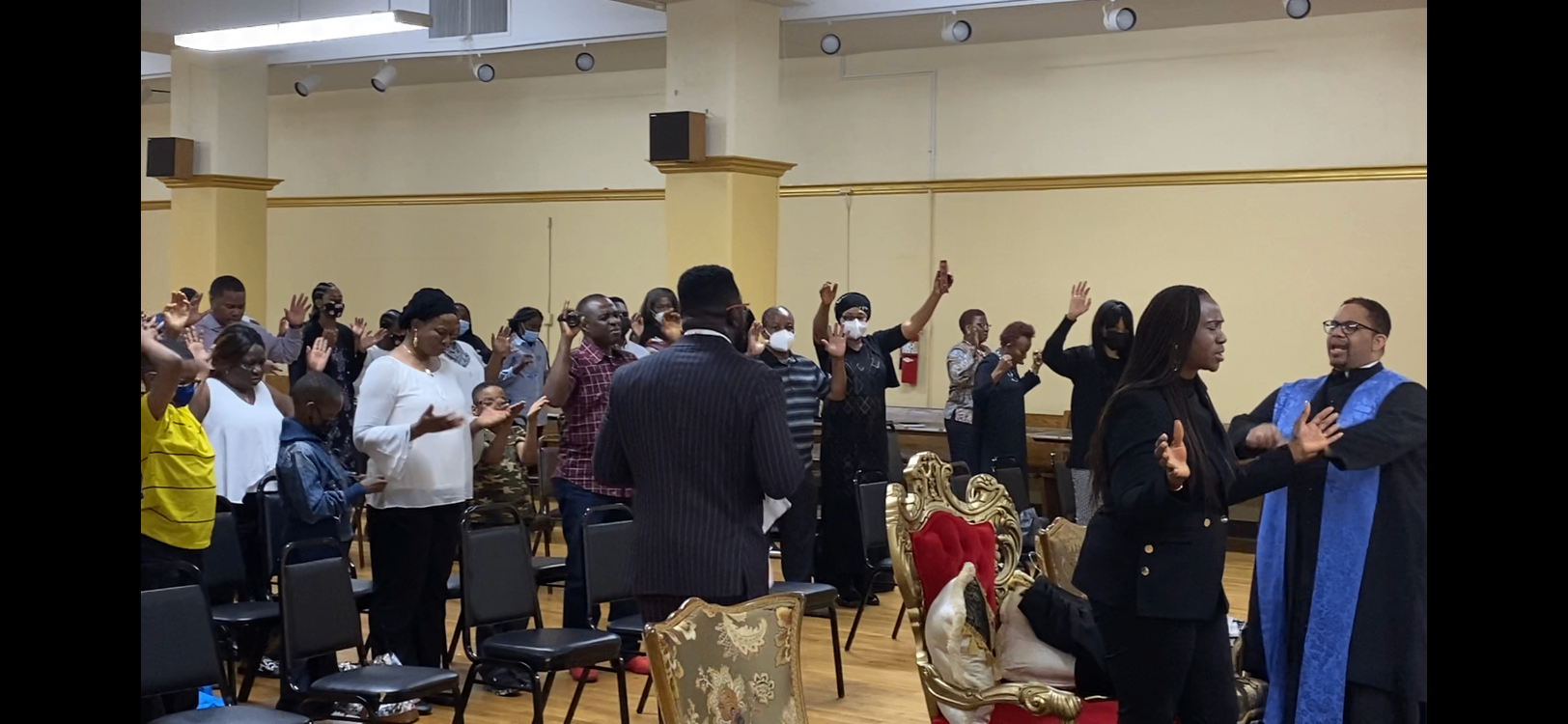 Worshippers raising their hands at Holy of Holies Tabernacle